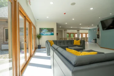 Modern common area at Indiana Center for Recovery Indianapolis, featuring bright natural light, comfortable seating, and welcoming atmosphere for clients.