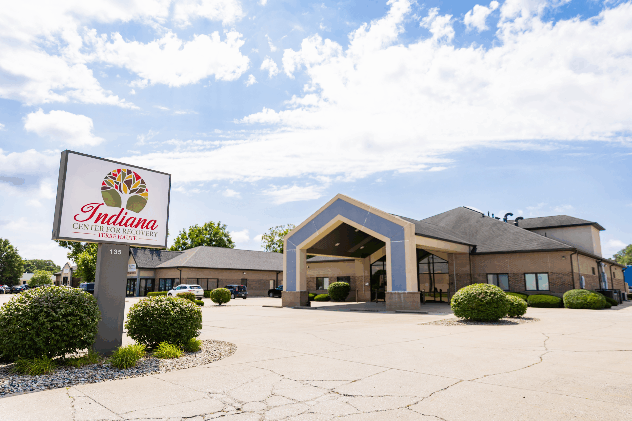 A professional photograph of the exterior of the Indiana Center for Recovery building in Terre Haute, Indiana, featuring the facility's sign with its logo and address number "135" clearly visible.