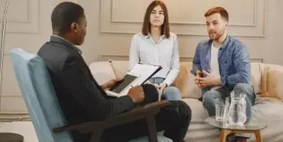 Adults in couples therapy. Therapy programs at rehab centers, like CBT and DBT, emphasize evidence-based practices for addiction recovery.