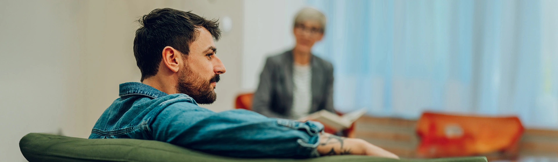 Man at therapy sitting on couch.