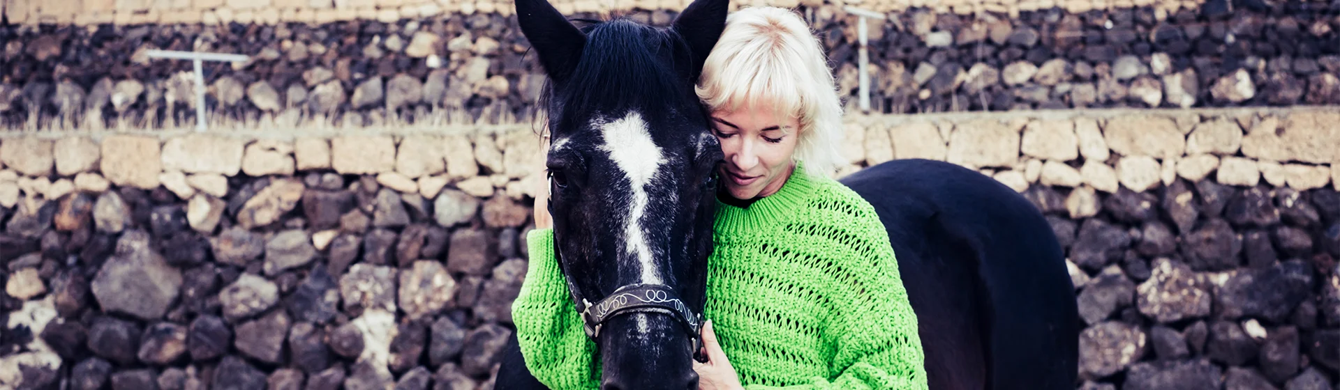 In an equine therapy session, a person bonds with a horse in a serene outdoor setting, promoting mental health and emotional healing.