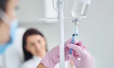 nurse holding up a needle for IV