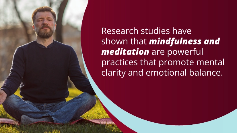 A text box on the right reads, "Research studies have shown that mindfulness and meditation are powerful practices that promote mental clarity and emotional balance." On the left, a man with a beard and a dark sweater sits cross-legged on a yoga mat outdoors, meditating with his eyes closed and hands resting on his knees. The background shows a sunny day with trees and blurred scenery.