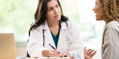 A doctor talking to her patient with a concerned look