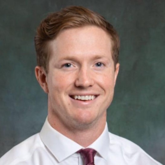 a man in a white shirt and red tie
