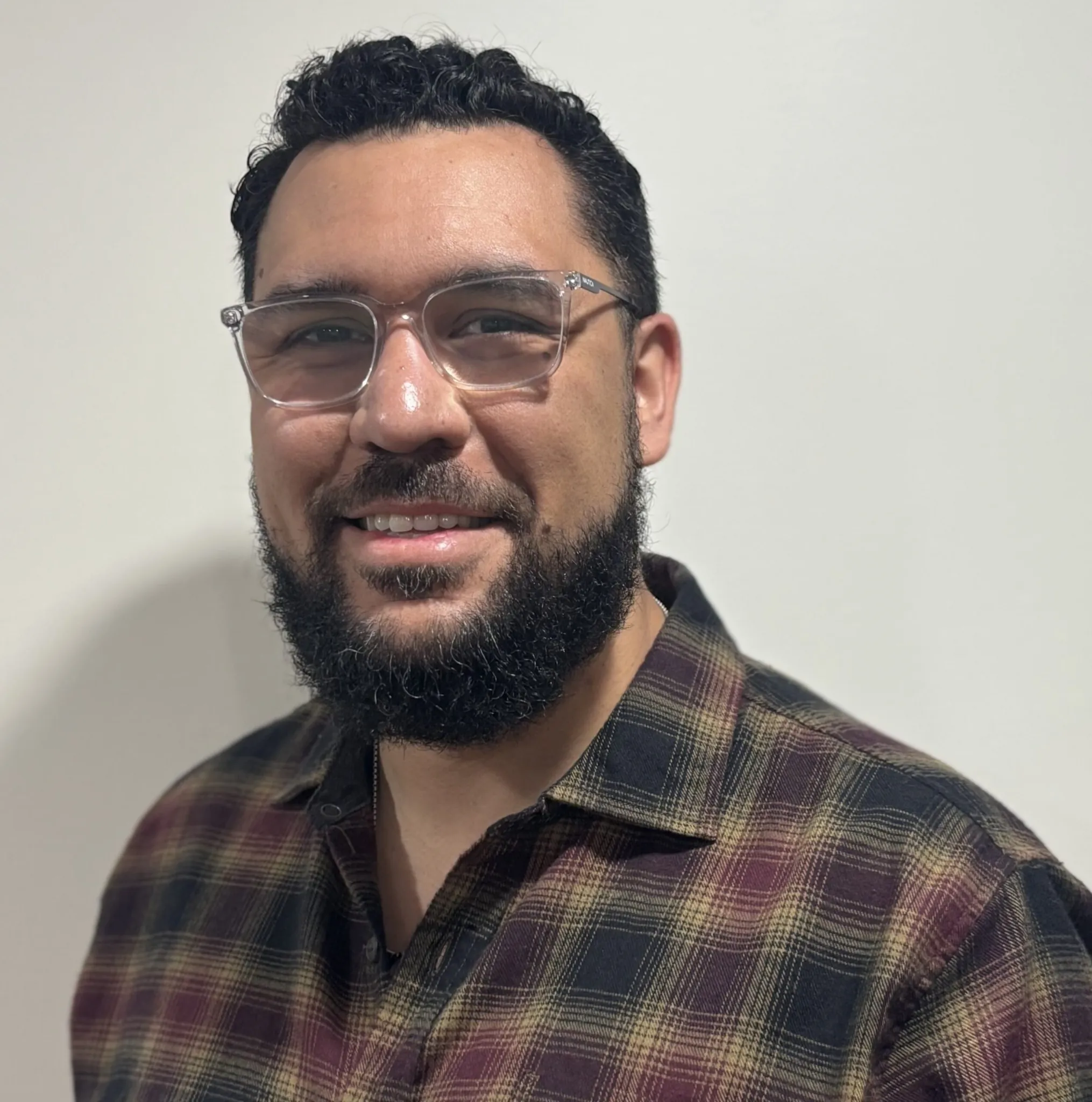 Portrait of Michael Kukulka, staff member at Indiana Center for Recovery, smiling in a plaid shirt against a neutral background