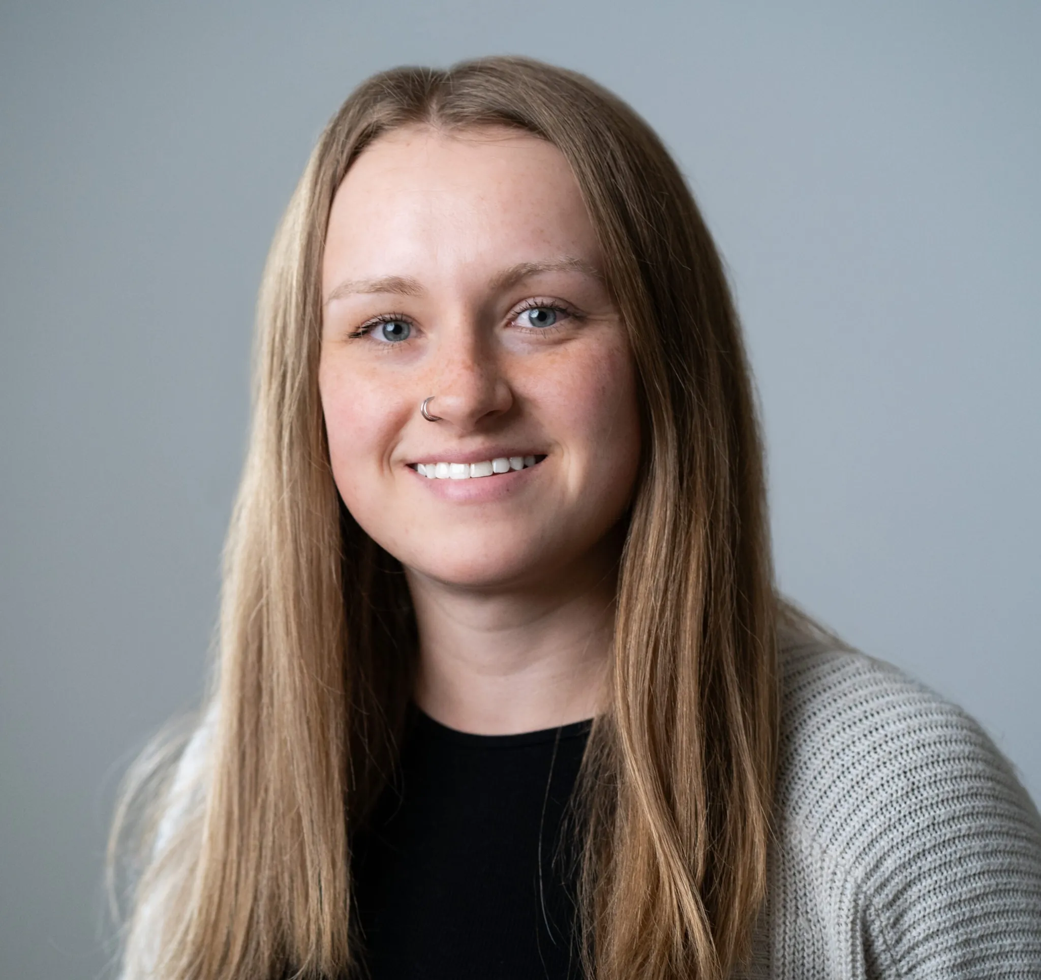 Headshot of Macy Olds, Indiana Center for Recovery staff member, smiling against a neutral gray background