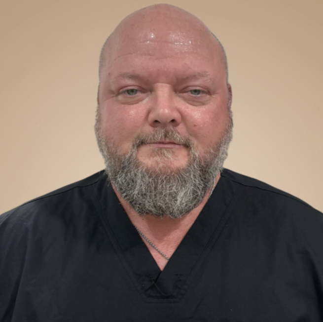 A portrait of a registered nurse wearing a black top