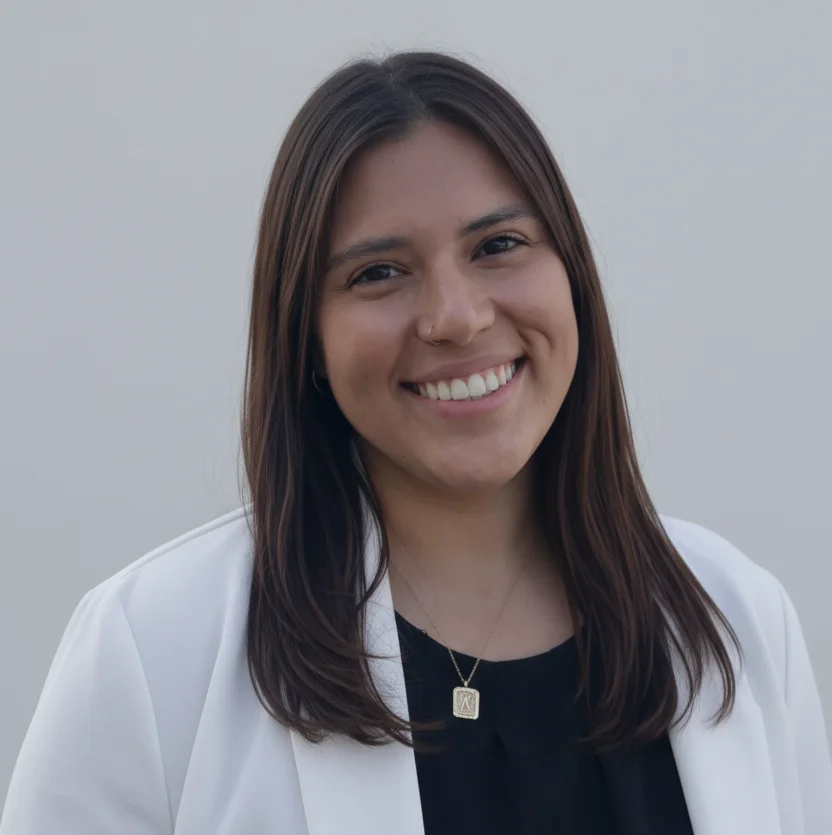 Professional headshot of Kiara Nieto, licensed therapist at Indiana Center for Recovery (ICFR), smiling outdoors in a white blazer, behavioral health professional portrait.